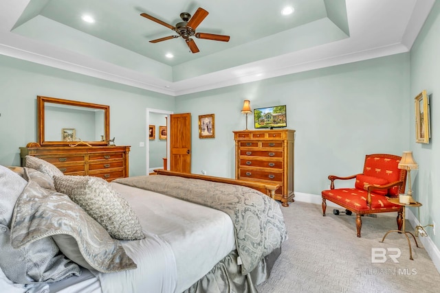 bedroom with a raised ceiling, light carpet, recessed lighting, and baseboards