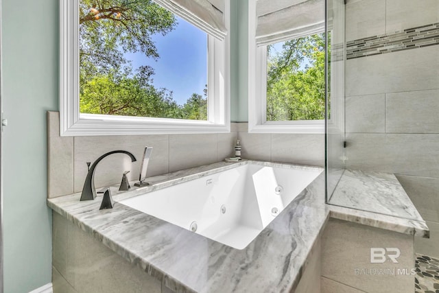 bathroom featuring a tub with jets