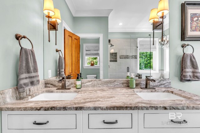 full bathroom featuring toilet, a sink, double vanity, and a stall shower