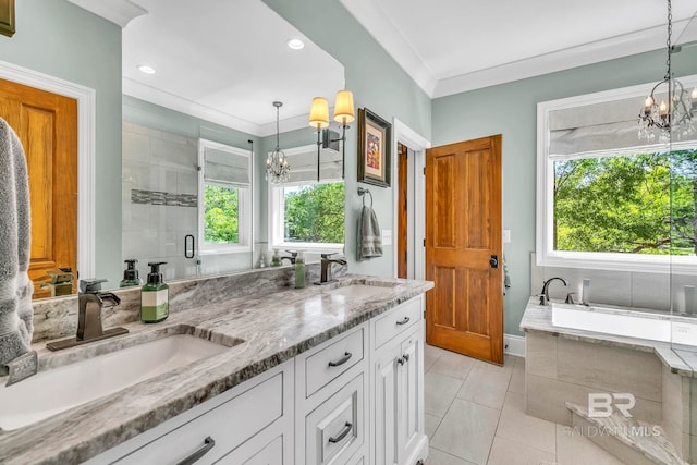 bathroom featuring a chandelier, a healthy amount of sunlight, and a sink
