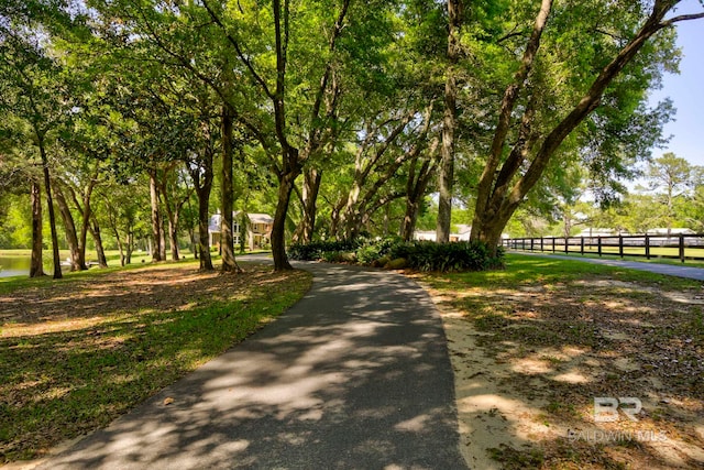 view of home's community featuring fence