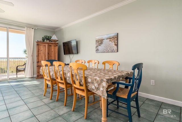 tiled dining area featuring ornamental molding and ceiling fan