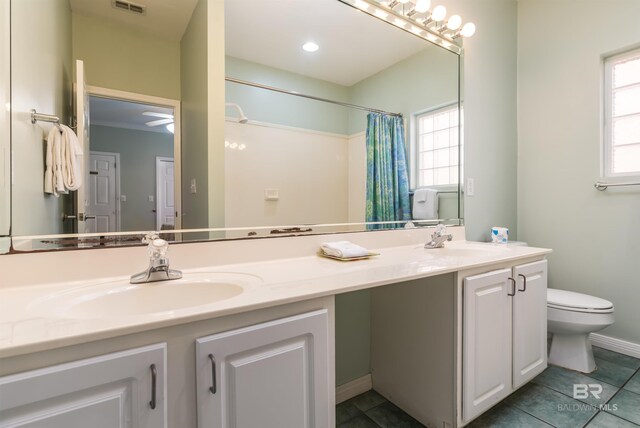 bathroom featuring vanity, toilet, a shower with shower curtain, and tile patterned floors