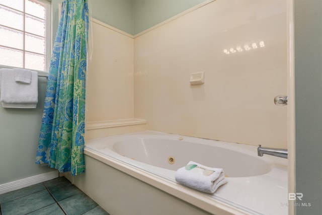 bathroom with tile patterned flooring and a washtub