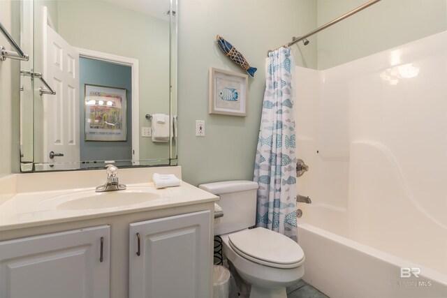 full bathroom with vanity, shower / bath combo with shower curtain, toilet, and tile patterned floors