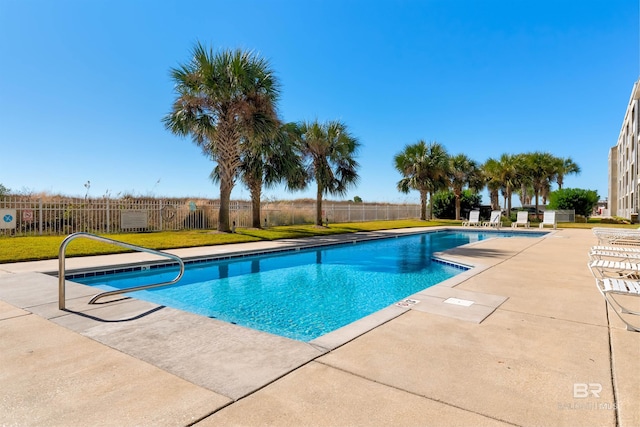 view of pool with a lawn and a patio area