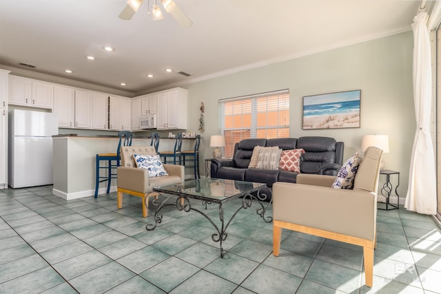 living room featuring crown molding, light tile patterned floors, and ceiling fan