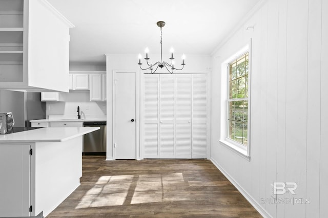 kitchen with white cabinets, hanging light fixtures, a healthy amount of sunlight, and stainless steel dishwasher