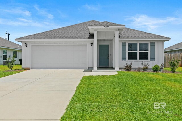 view of front of property with a garage and a front lawn