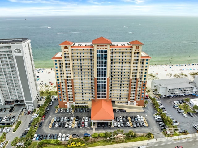 bird's eye view with a water view and a beach view