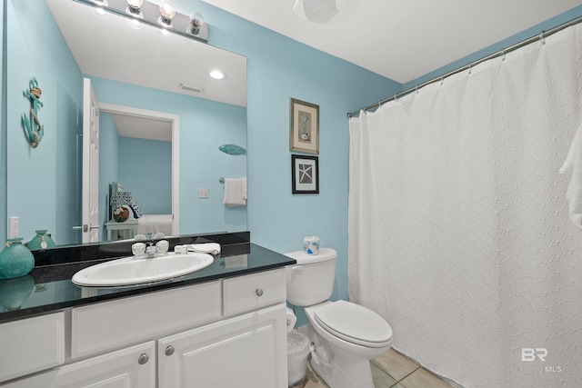 bathroom featuring toilet, vanity, and tile patterned flooring