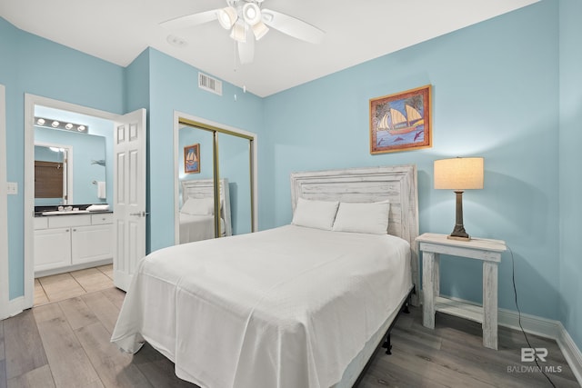 bedroom with ceiling fan, light hardwood / wood-style floors, connected bathroom, and a closet