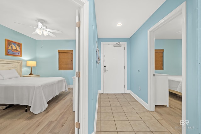 bedroom with ceiling fan and light wood-type flooring