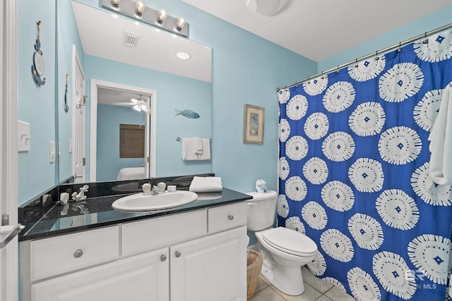 bathroom featuring toilet, tile patterned floors, ceiling fan, and vanity