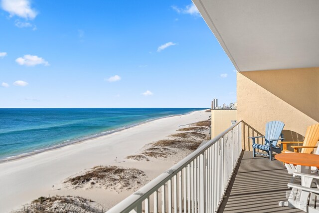 balcony with a water view and a beach view