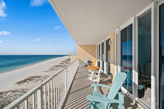 balcony with a water view and a beach view