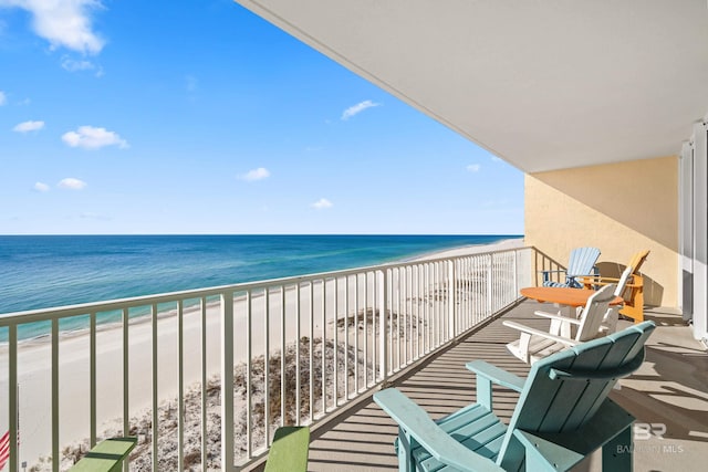 balcony with a beach view and a water view