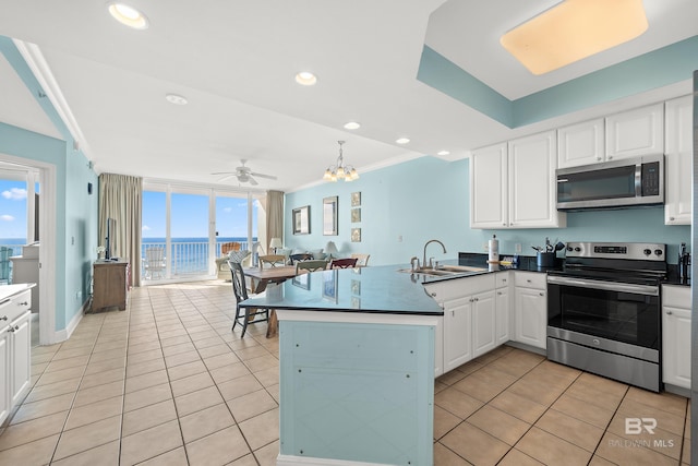 kitchen featuring kitchen peninsula, crown molding, sink, white cabinetry, and stainless steel appliances