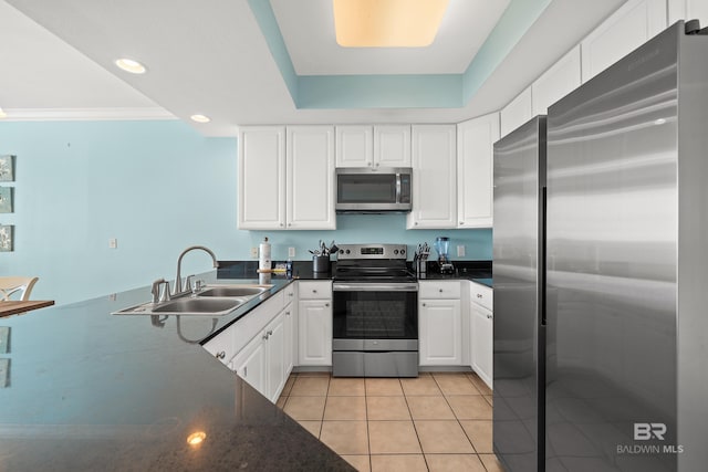 kitchen featuring white cabinets, appliances with stainless steel finishes, sink, light tile patterned floors, and crown molding