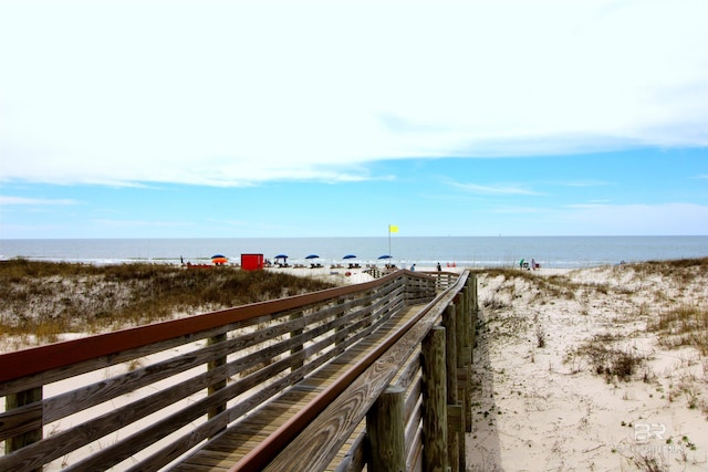 surrounding community with a view of the beach and a water view