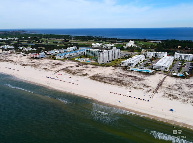 drone / aerial view with a beach view and a water view