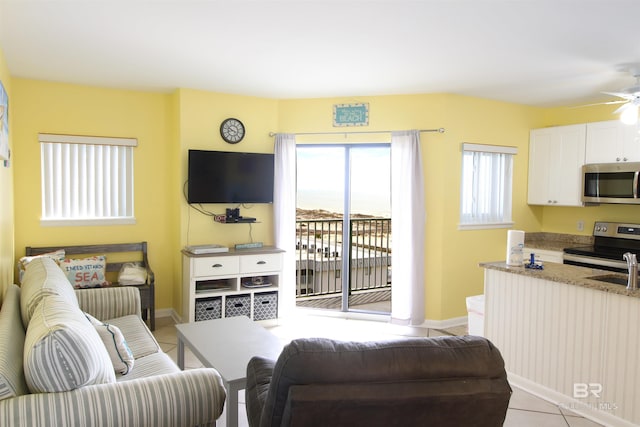 tiled living room with sink and ceiling fan