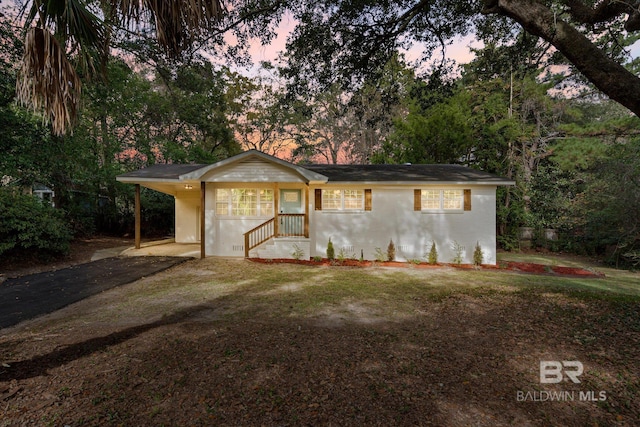 ranch-style home featuring a carport