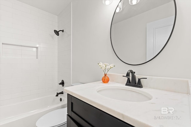 full bathroom featuring vanity, toilet, and tiled shower / bath