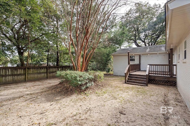 view of yard featuring a wooden deck