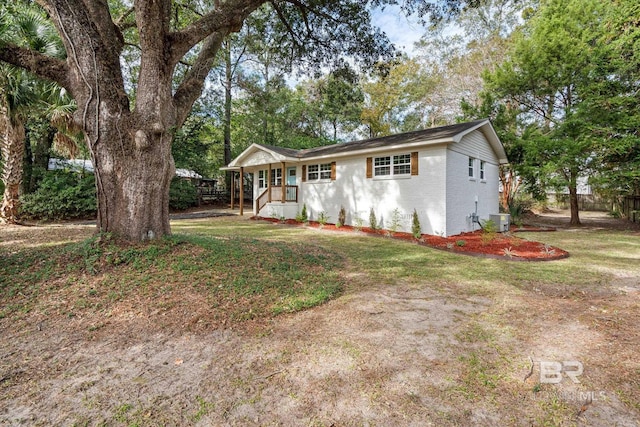 ranch-style home with a front yard and central AC