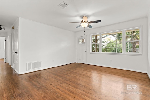 unfurnished room featuring dark hardwood / wood-style floors, ceiling fan, and crown molding