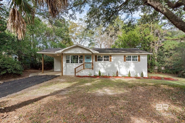 ranch-style home with a carport and a front yard