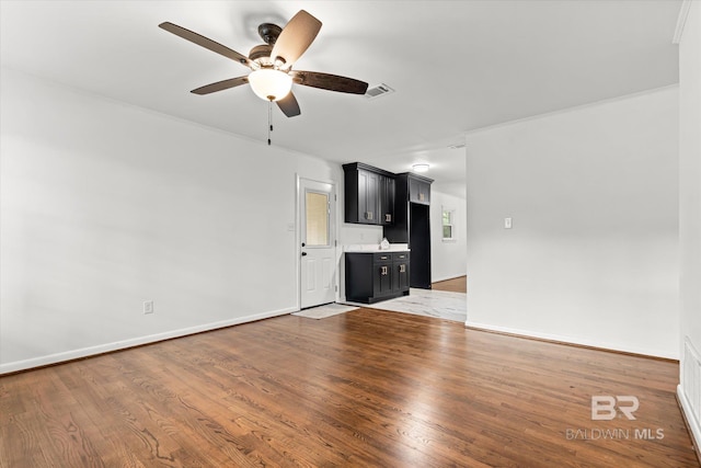 unfurnished living room with ceiling fan and hardwood / wood-style floors