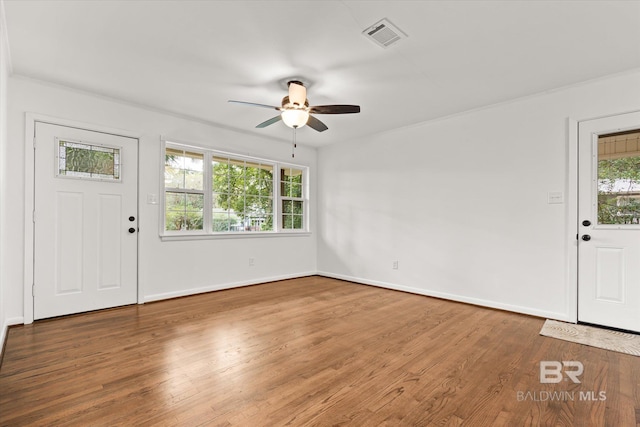 foyer entrance with a wealth of natural light, ceiling fan, and wood-type flooring