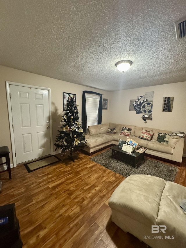 living room featuring hardwood / wood-style flooring and a textured ceiling