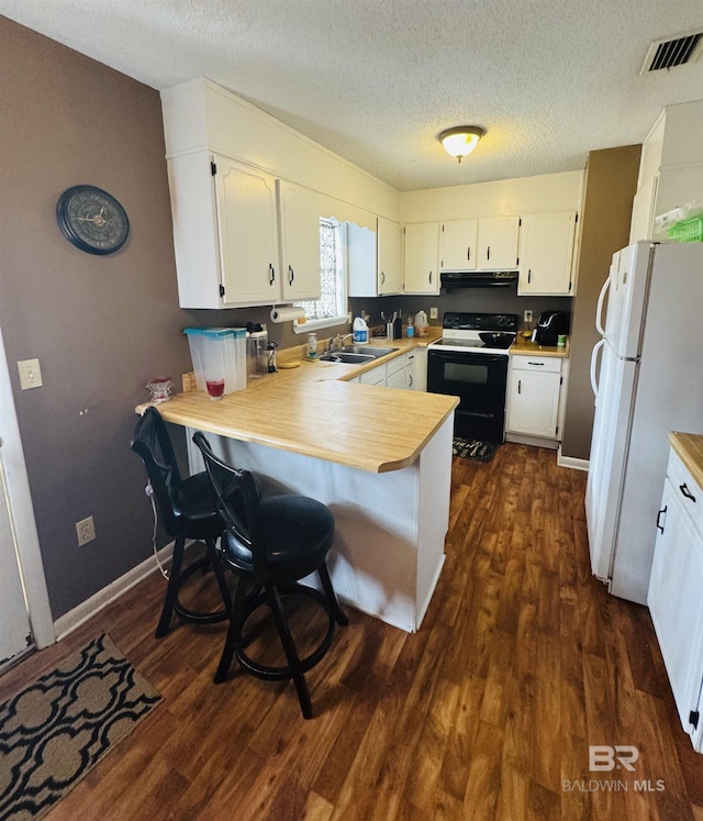 kitchen featuring white cabinetry, electric range, kitchen peninsula, and white refrigerator