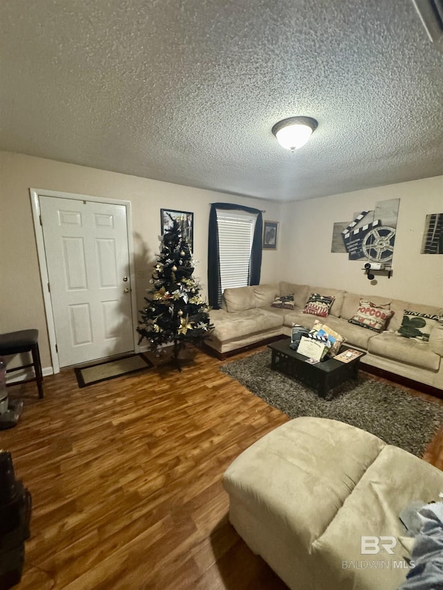 living room featuring hardwood / wood-style flooring and a textured ceiling