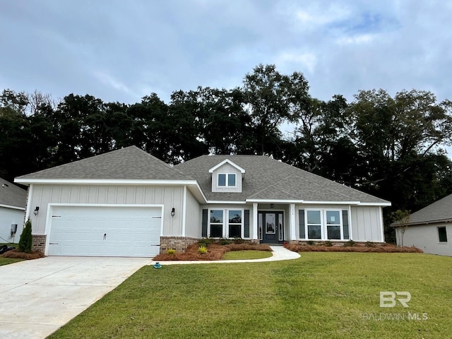 craftsman-style home featuring a front yard and a garage