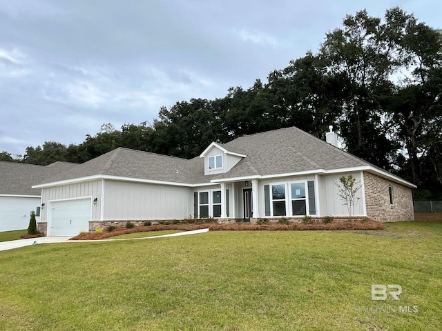 view of front of home with a garage and a front lawn