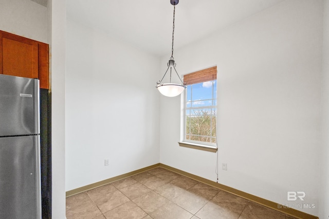 unfurnished dining area with light tile floors