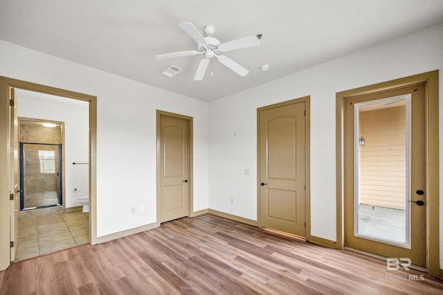 unfurnished bedroom with ceiling fan, ensuite bath, and light hardwood / wood-style floors