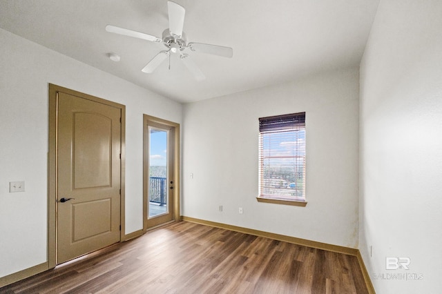 empty room with ceiling fan and hardwood / wood-style flooring