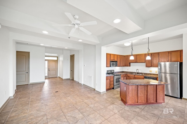 kitchen with ceiling fan, stainless steel appliances, light tile flooring, pendant lighting, and a center island