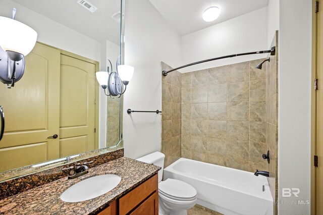 full bathroom with tiled shower / bath, toilet, and large vanity