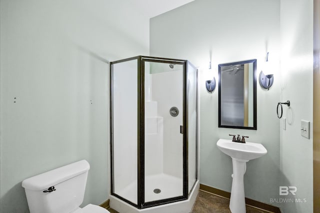 bathroom featuring tile floors, an enclosed shower, and toilet