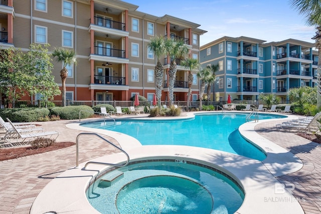 view of pool with a hot tub