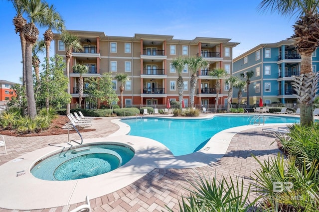 view of swimming pool with a community hot tub