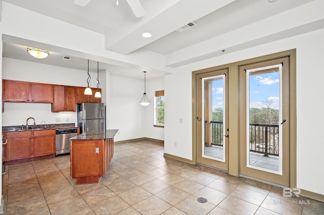 kitchen with a center island, appliances with stainless steel finishes, decorative light fixtures, ceiling fan, and light tile floors