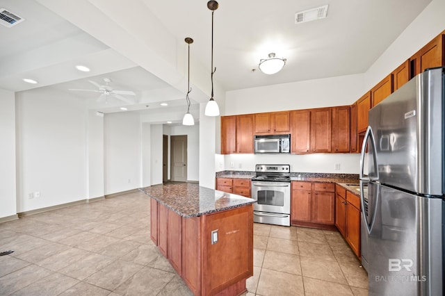 kitchen with a kitchen island, appliances with stainless steel finishes, pendant lighting, ceiling fan, and light tile floors