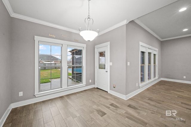 unfurnished dining area featuring light hardwood / wood-style flooring and ornamental molding